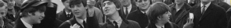 A photo of The Beatles from Beatles '64.  From left to Right: John, Paul, George, Ringo. A long strip mostly showing their faces and shoulders. A crowd stands behind them.