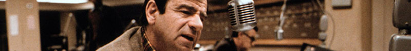 Walter Matthau speaking into a microphone.